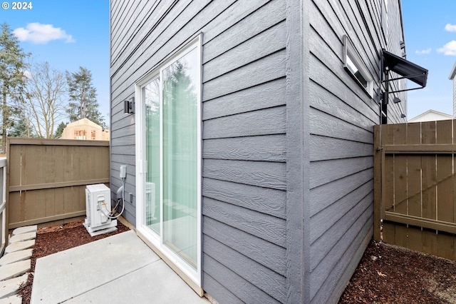 view of property exterior featuring ac unit and a patio area