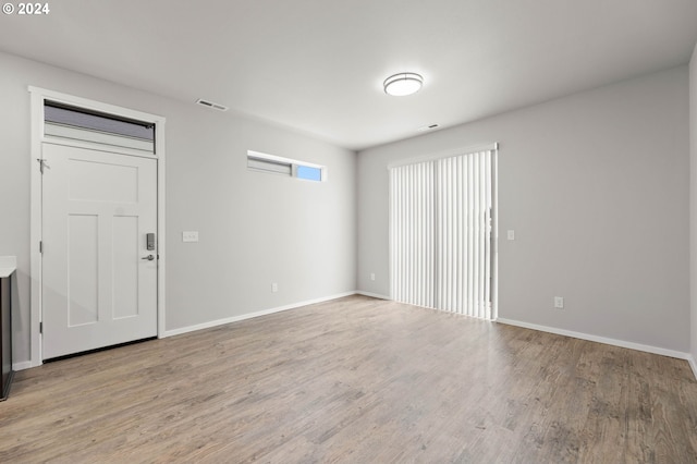 unfurnished room with light hardwood / wood-style flooring