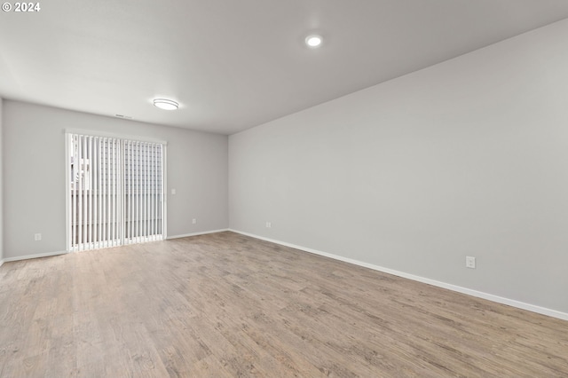 unfurnished room with light hardwood / wood-style floors