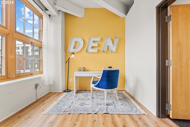 unfurnished office featuring high vaulted ceiling, beamed ceiling, and hardwood / wood-style flooring