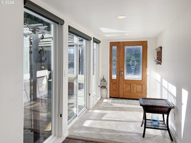 tiled foyer featuring a wealth of natural light