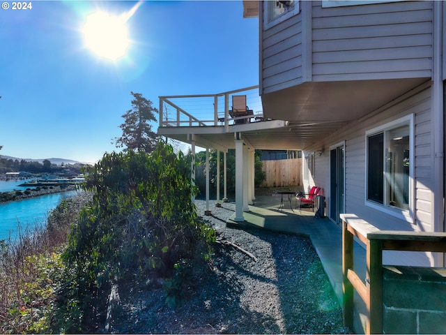 view of yard featuring a water view and a patio area