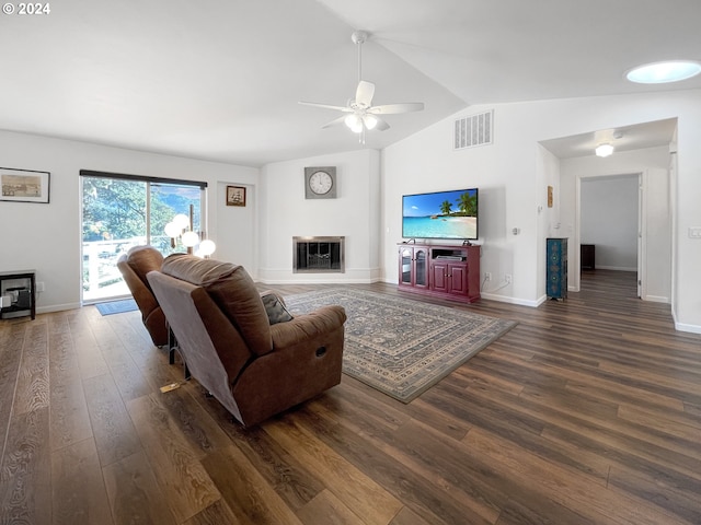 living room featuring vaulted ceiling, ceiling fan, and dark hardwood / wood-style flooring