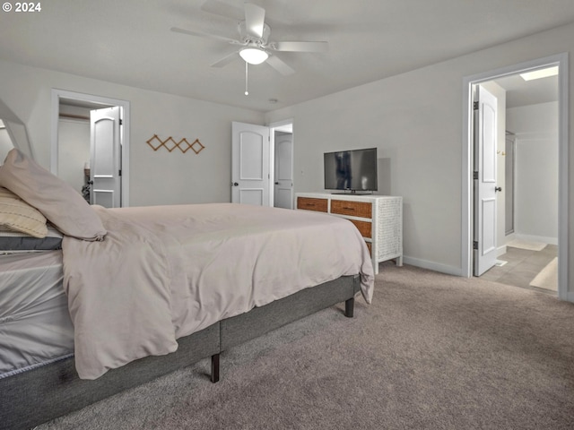 carpeted bedroom featuring ceiling fan and ensuite bathroom