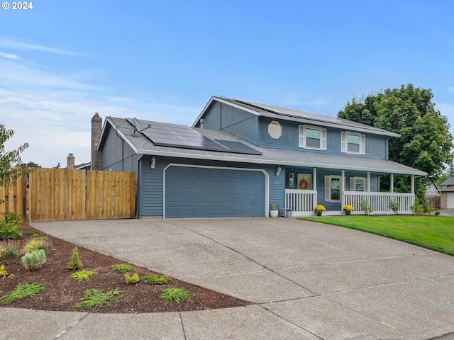 view of front of property with a front yard, covered porch, solar panels, and a garage