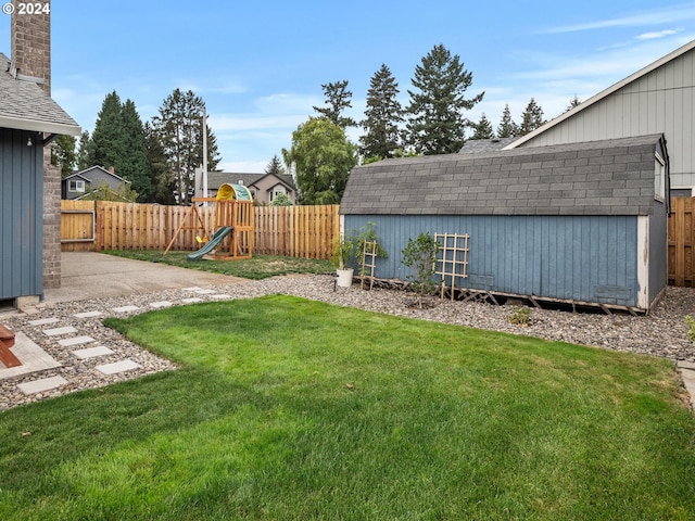 view of yard featuring a storage shed and a playground