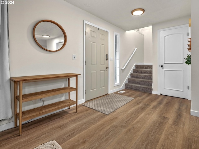 foyer with dark hardwood / wood-style flooring