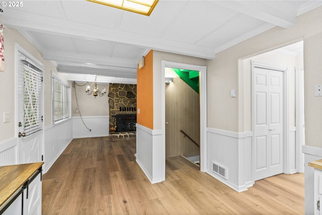 5213 Hilltop Dr, Florence, OR 97439 - hallway with an upstairs landing, light wood finished floors, a chandelier, a wainscoted wall, and crown molding