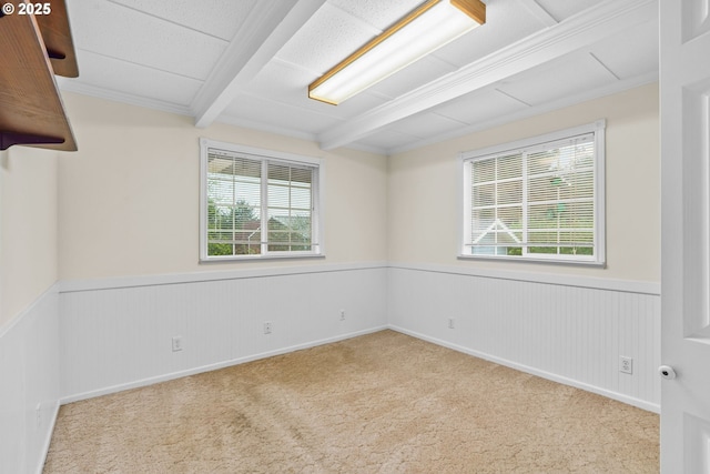 5213 Hilltop Dr, Florence, OR 97439 - carpeted empty room featuring plenty of natural light, wainscoting, and beam ceiling