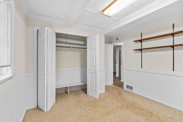 5213 Hilltop Dr, Florence, OR 97439 - unfurnished bedroom featuring wainscoting, carpet floors, a closet, crown molding, and a decorative wall