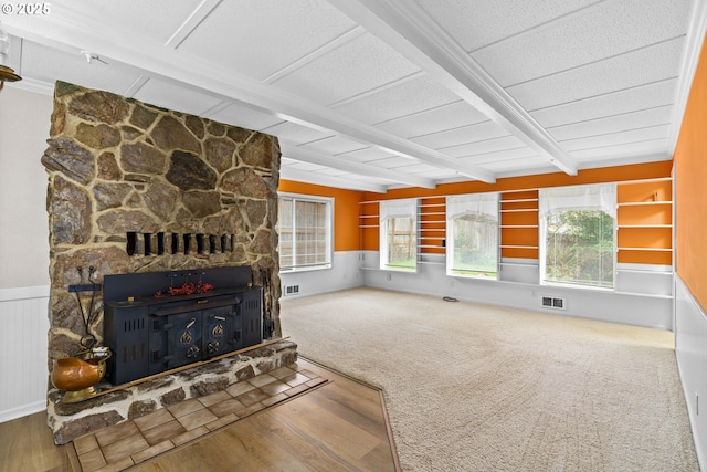 5213 Hilltop Dr, Florence, OR 97439 - unfurnished living room featuring beam ceiling, healthy amount of natural light, wood finished floors, and wainscoting