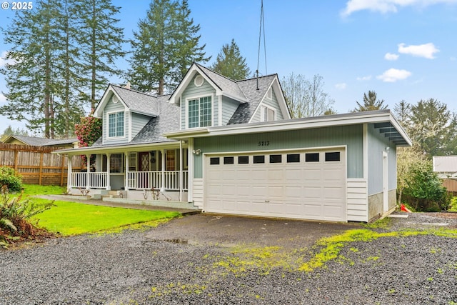 5213 Hilltop Dr, Florence, OR 97439 - view of front of property featuring a porch, roof with shingles, fence, and a garage