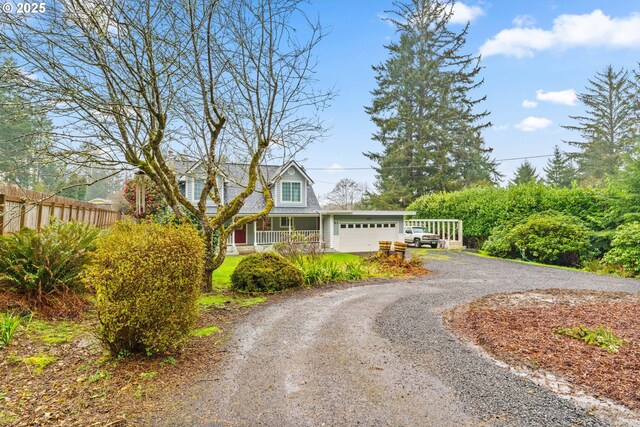 5213 Hilltop Dr, Florence, OR 97439 - view of front of property with dirt driveway, fence, and a garage