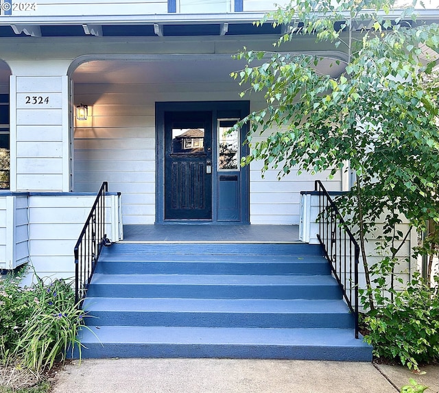 view of exterior entry featuring a porch