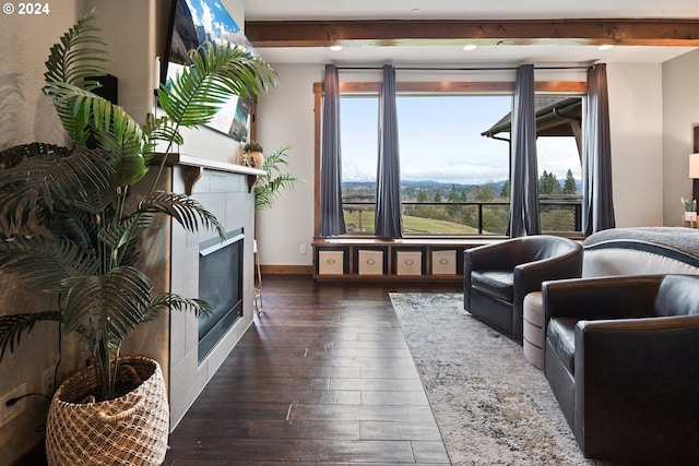 living area with dark wood-type flooring and beam ceiling