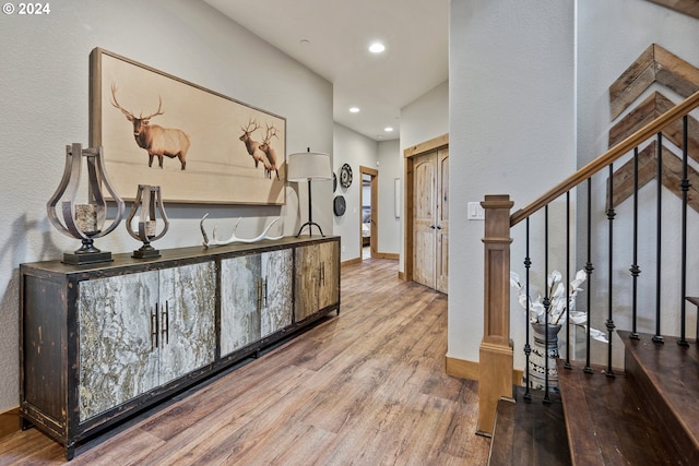 hall featuring a chandelier and hardwood / wood-style floors