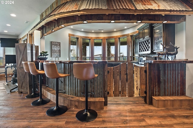 bar with dark wood-type flooring