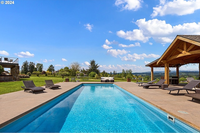 view of swimming pool with a lawn and a patio