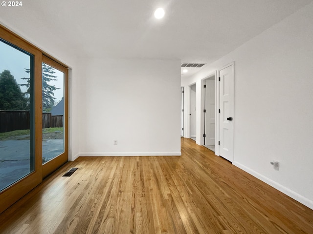 unfurnished room with light hardwood / wood-style floors