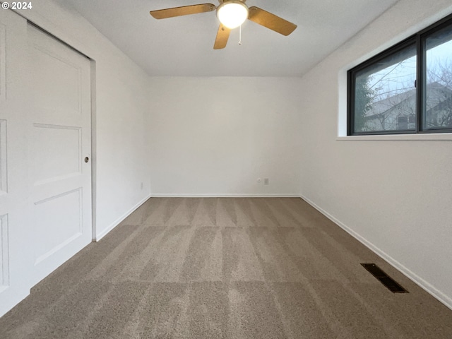 spare room with carpet flooring and ceiling fan