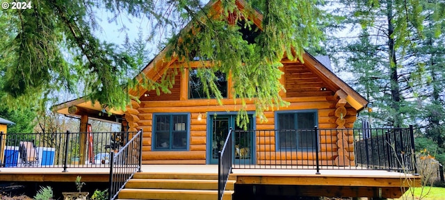 back of property featuring a wooden deck