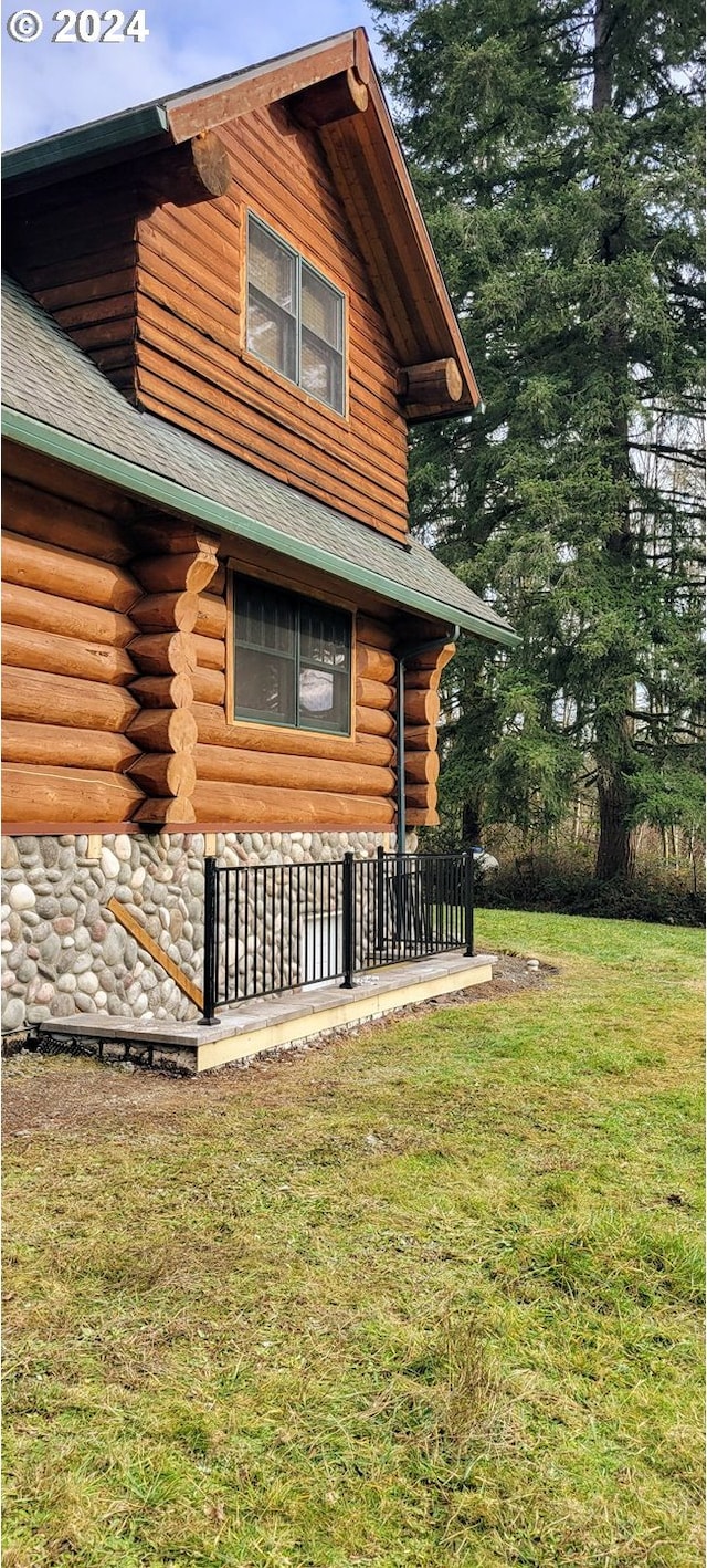 view of side of home with a lawn