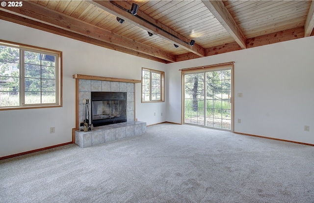 34540 Nestucca Blvd, Cloverdale, OR 97112 - unfurnished living room with wooden ceiling with exposed beams, carpet floors, a tile fireplace, and baseboards