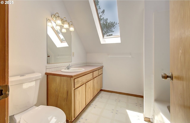 34540 Nestucca Blvd, Cloverdale, OR 97112 - full bathroom featuring a skylight, tile patterned floors, vanity, toilet, and vaulted ceiling