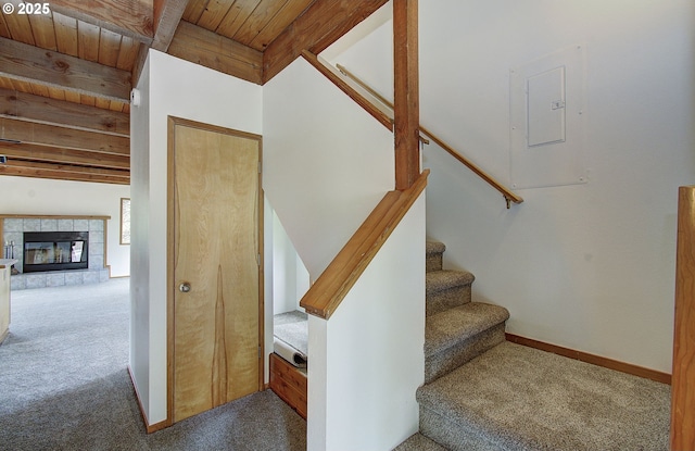 34540 Nestucca Blvd, Cloverdale, OR 97112 - stairs with carpet flooring, wooden ceiling with exposed beams, baseboards, and a tiled fireplace