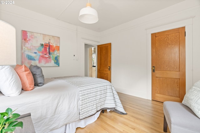 bedroom with hardwood / wood-style floors