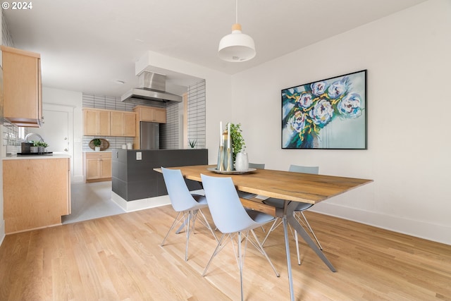 dining space with light hardwood / wood-style floors