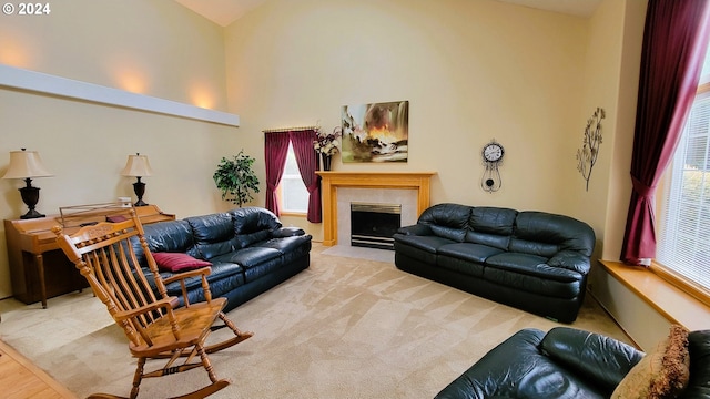 living room with a tile fireplace and light hardwood / wood-style flooring