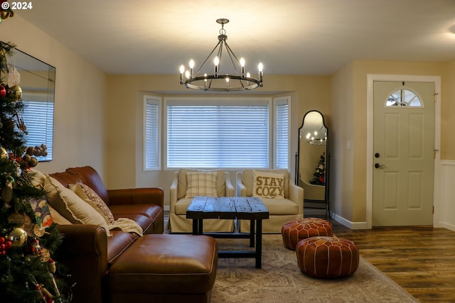 sitting room featuring wood-type flooring and a notable chandelier