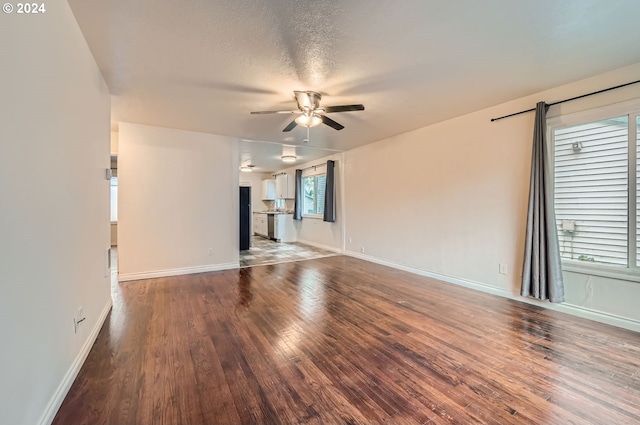 unfurnished living room with hardwood / wood-style flooring, a textured ceiling, and ceiling fan