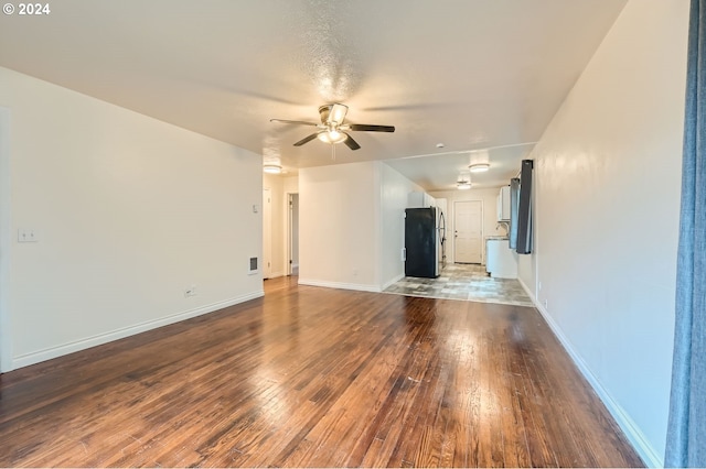 unfurnished living room featuring wood-type flooring and ceiling fan