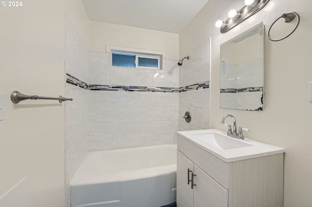 bathroom with tiled shower / bath and vanity