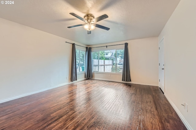 unfurnished room featuring ceiling fan, a textured ceiling, and dark wood-type flooring