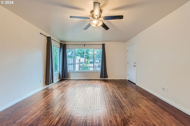 empty room featuring ceiling fan and dark hardwood / wood-style flooring