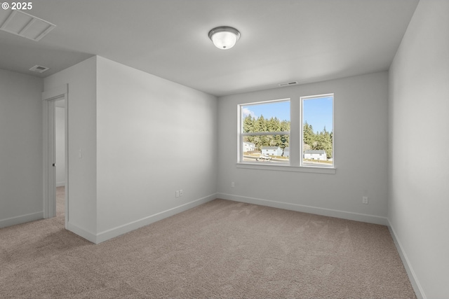 empty room featuring light colored carpet