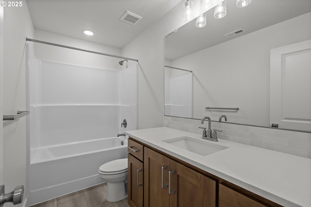 full bathroom featuring backsplash, vanity, wood-type flooring, bathtub / shower combination, and toilet