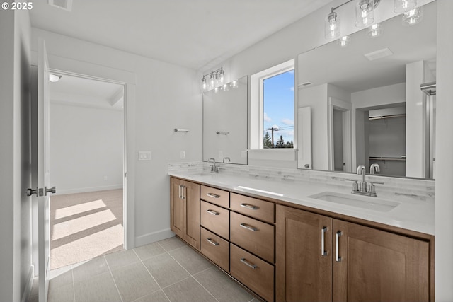 bathroom featuring tasteful backsplash, vanity, and tile patterned floors