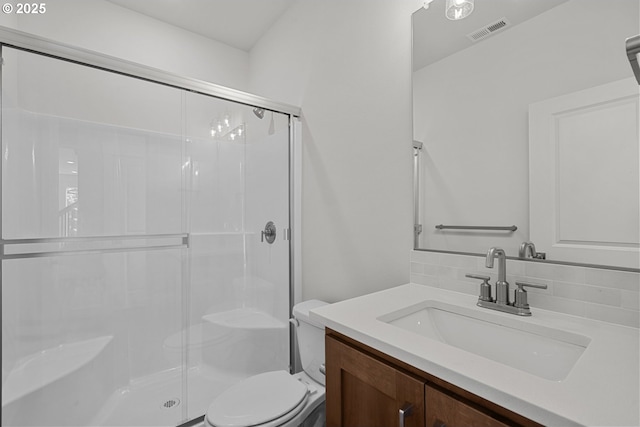 bathroom with an enclosed shower, vanity, decorative backsplash, and toilet