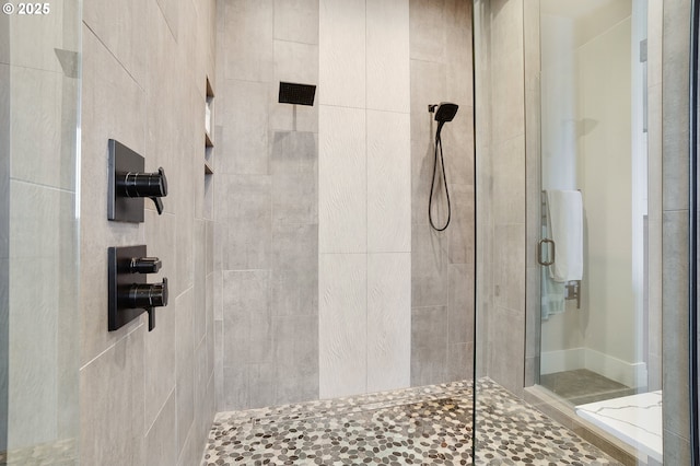 bathroom featuring a shower with door