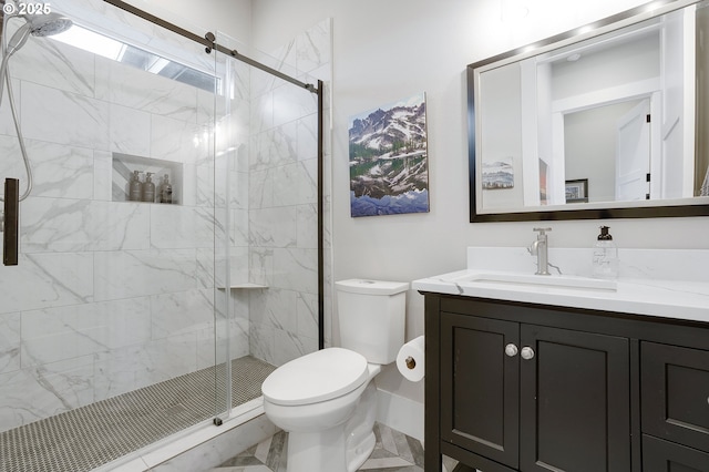 bathroom featuring vanity, toilet, and a shower with door