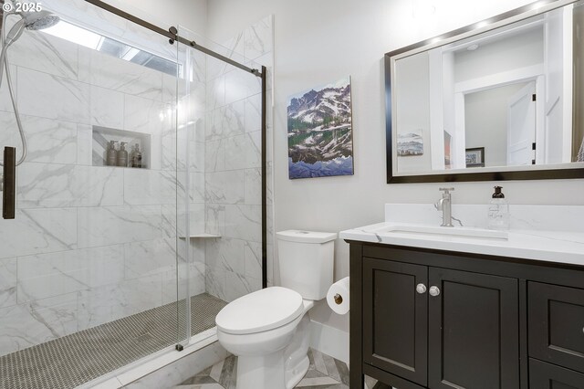 bathroom featuring a stall shower, vanity, and toilet