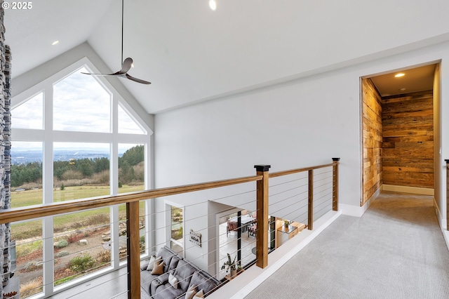 hall featuring light carpet and lofted ceiling