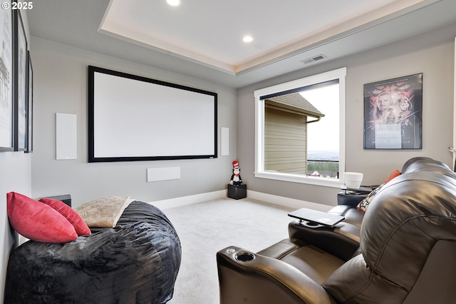 home theater featuring carpet floors and a tray ceiling