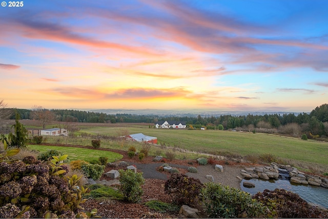 aerial view at dusk featuring a rural view