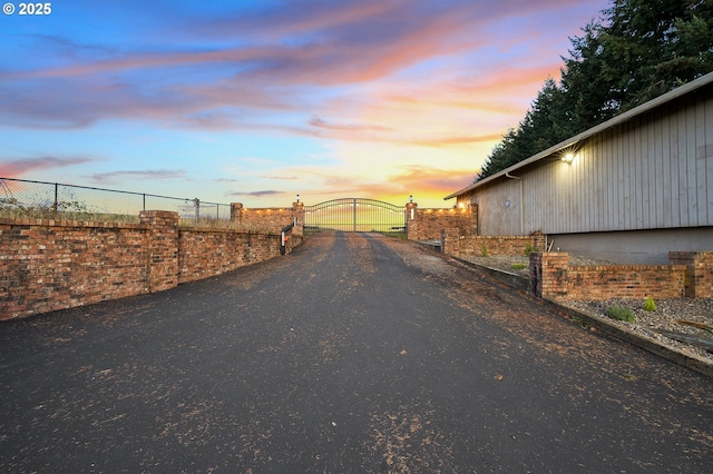 view of street with a gate and driveway