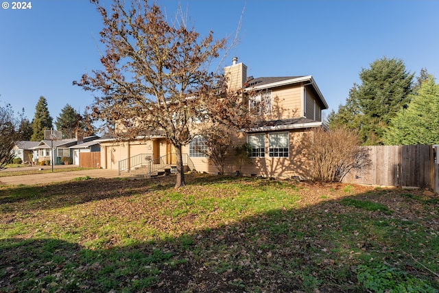 back of house featuring a yard